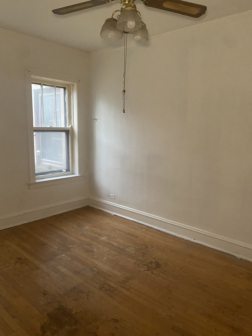 2233 East 70th Place, Unit 1 Chicago, IL 60649 - Photo 10 of 17 an empty room with windows