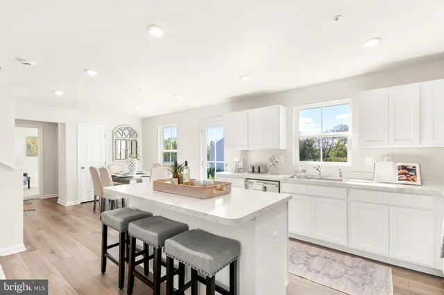 a view of a a dining room with furniture window and wooden floor