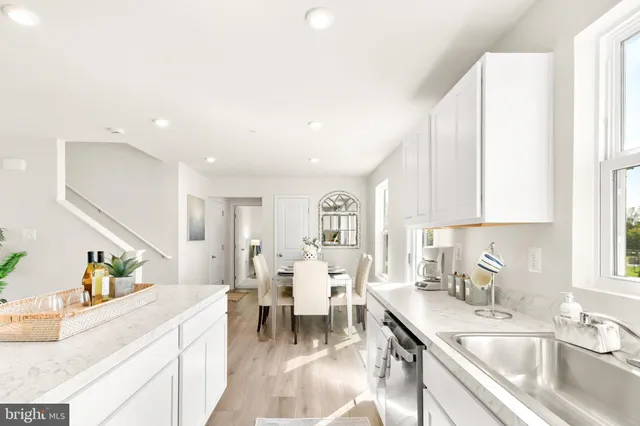 a view of a a dining room with furniture window and wooden floor