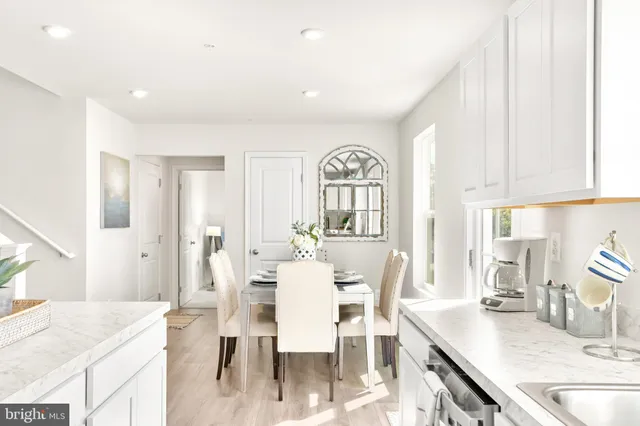 a kitchen with stainless steel appliances kitchen island granite countertop a sink a stove top oven a counter space and cabinets