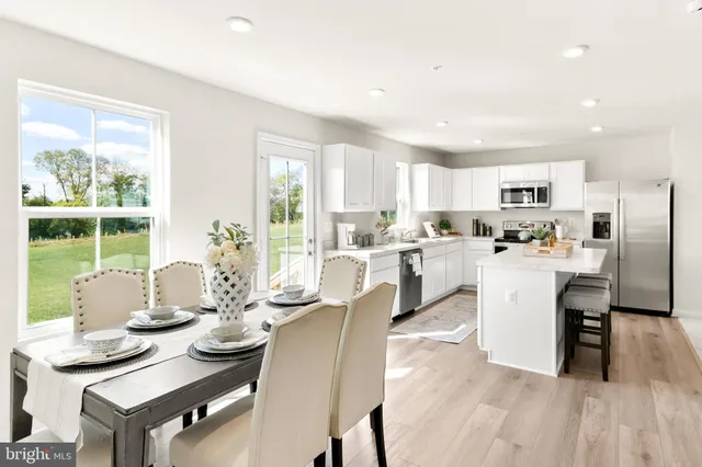 a living room with furniture kitchen and a table