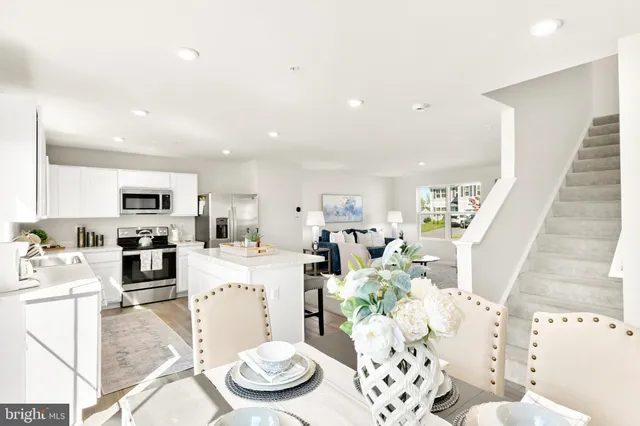 a view of a dining room with furniture wooden floor and windows