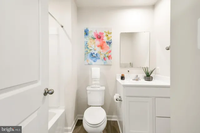 a bathroom with a shower curtain and a toilet