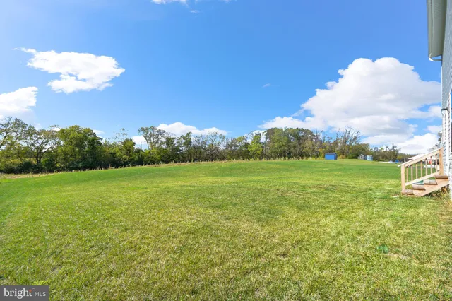 a view of a big room with table and chairs