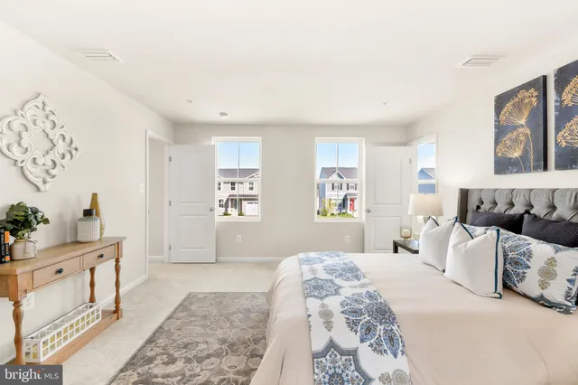 a bedroom with a large bed and a window