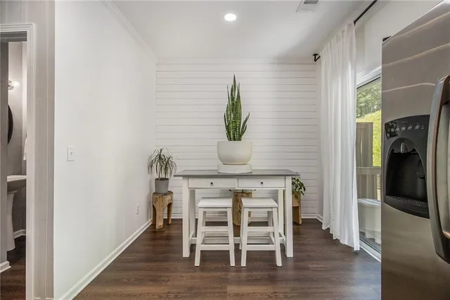 a dining room with furniture and wooden floor