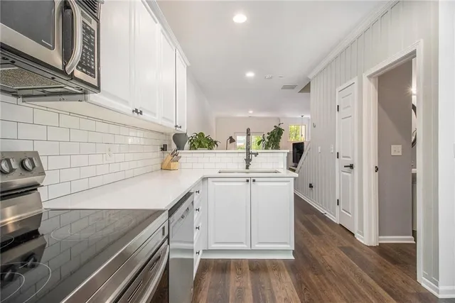 a kitchen with a sink and a stove top oven