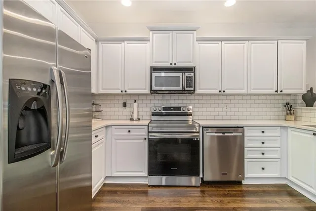 a kitchen with cabinets stainless steel appliances and a sink