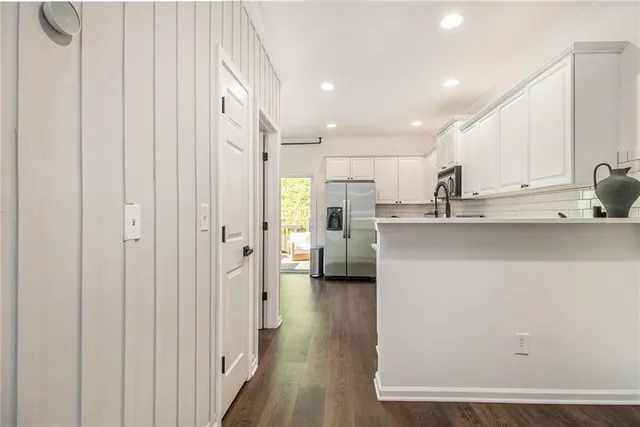 a kitchen with stainless steel appliances a refrigerator and a sink
