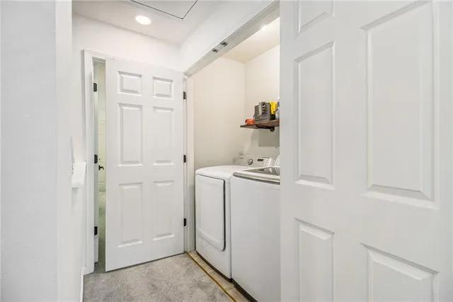 a view of a house with stairs and wooden fence