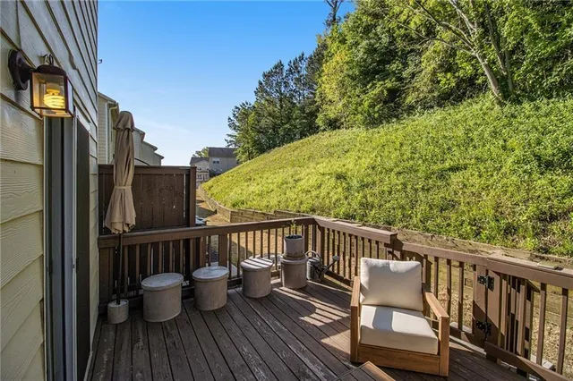 a view of balcony with wooden floor and outdoor seating