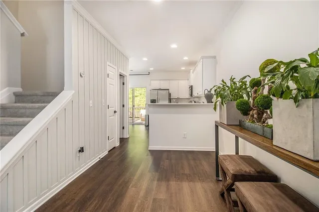 a kitchen with wooden floor and white appliances