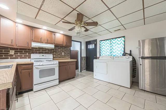 a kitchen with a stove sink and cabinets