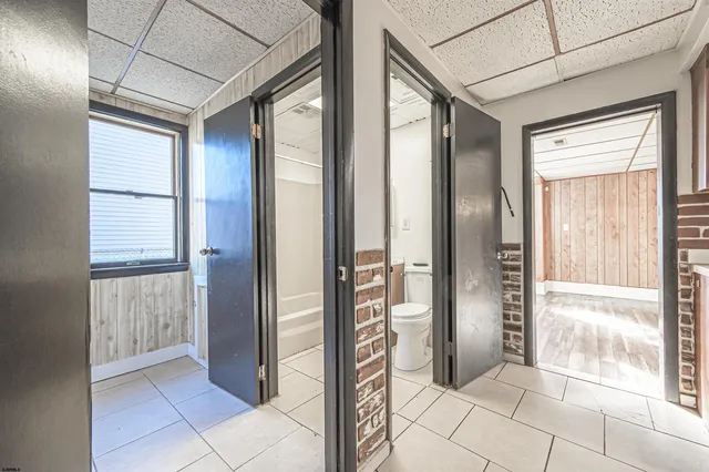 a view of a room with wooden floor and windows