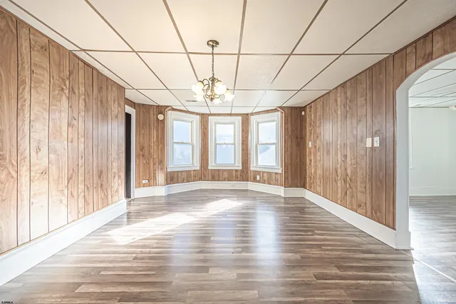 a view of a room with wooden floor and windows