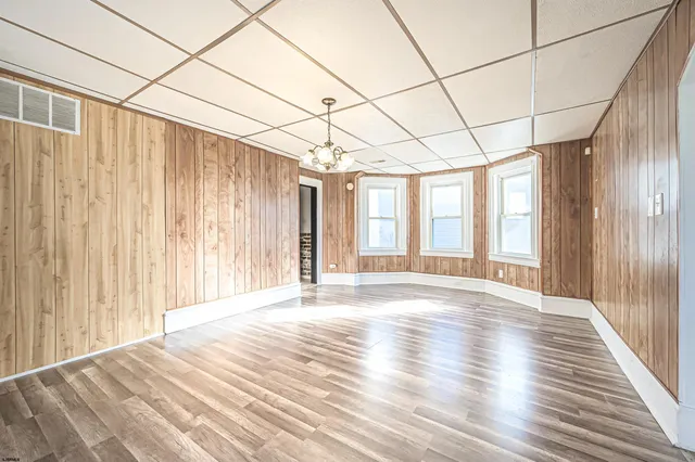 a view of a hallway with wooden floor and stairs