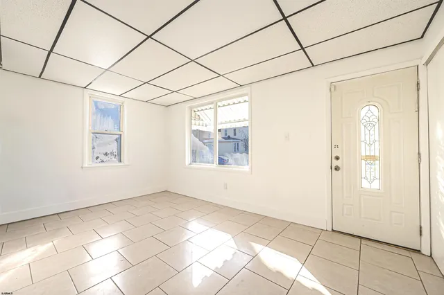 a view of a room with a white walls and a window