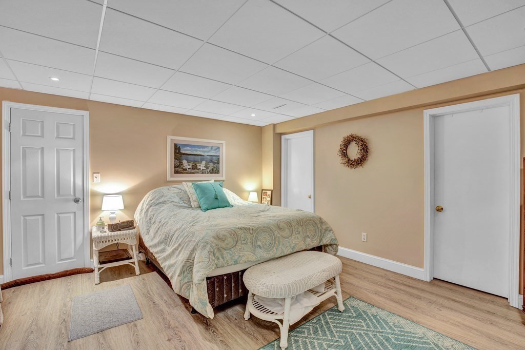 171 Scotland Road Newbury, MA 01951 - Photo 18 of 20 a bedroom with a bed and wooden floor