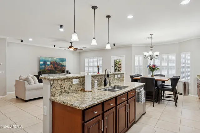 a kitchen with stainless steel appliances granite countertop a refrigerator a stove a sink and a wooden cabinets