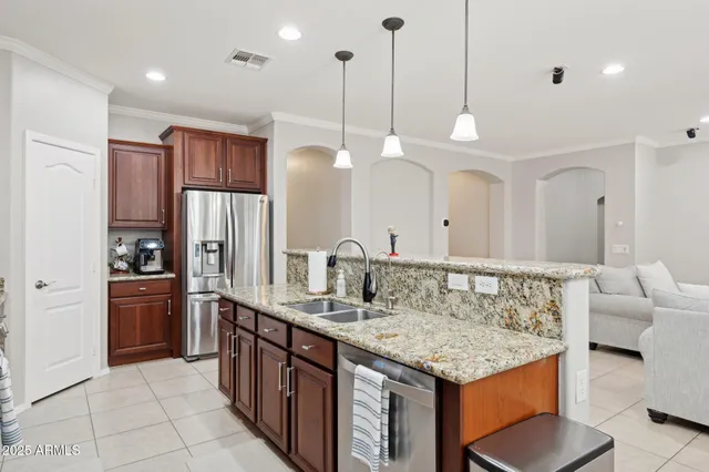 a dining room with wooden floor a chandelier a wooden table and chairs