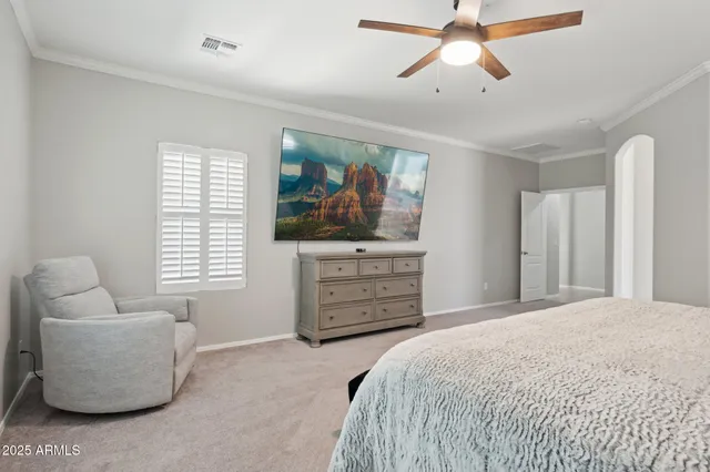 a bedroom with a bed window and a ceiling fan