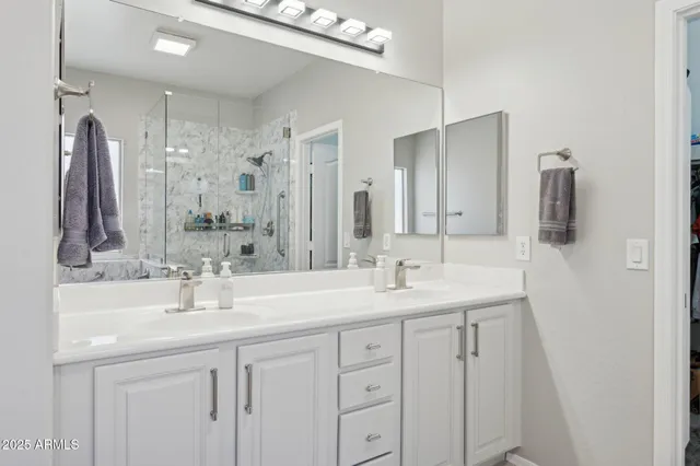 a large bed sitting in a bedroom next to a window