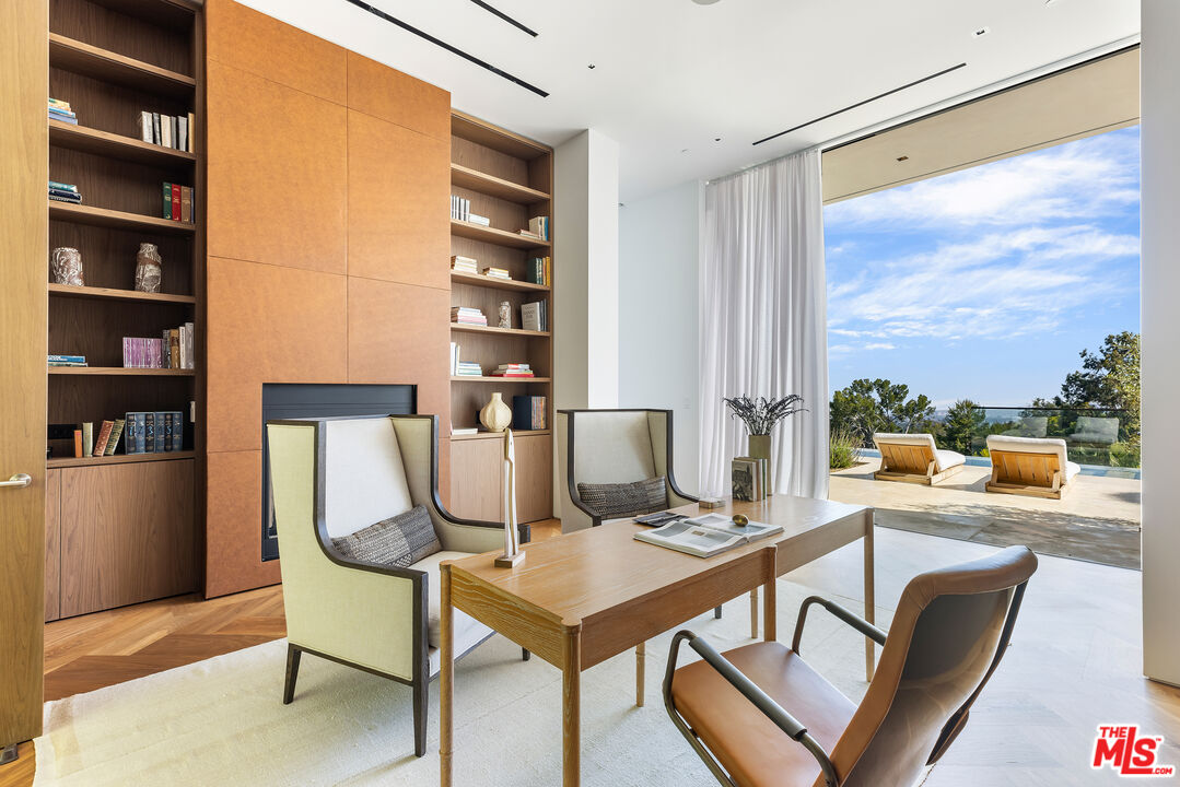 755 Sarbonne Road Los Angeles, CA 90077 - Photo 11 of 24 a living room with furniture a rug and a large window