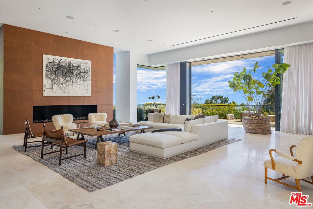 755 Sarbonne Road Los Angeles, CA 90077 - Photo 5 of 24 a living room with fireplace furniture and a large window