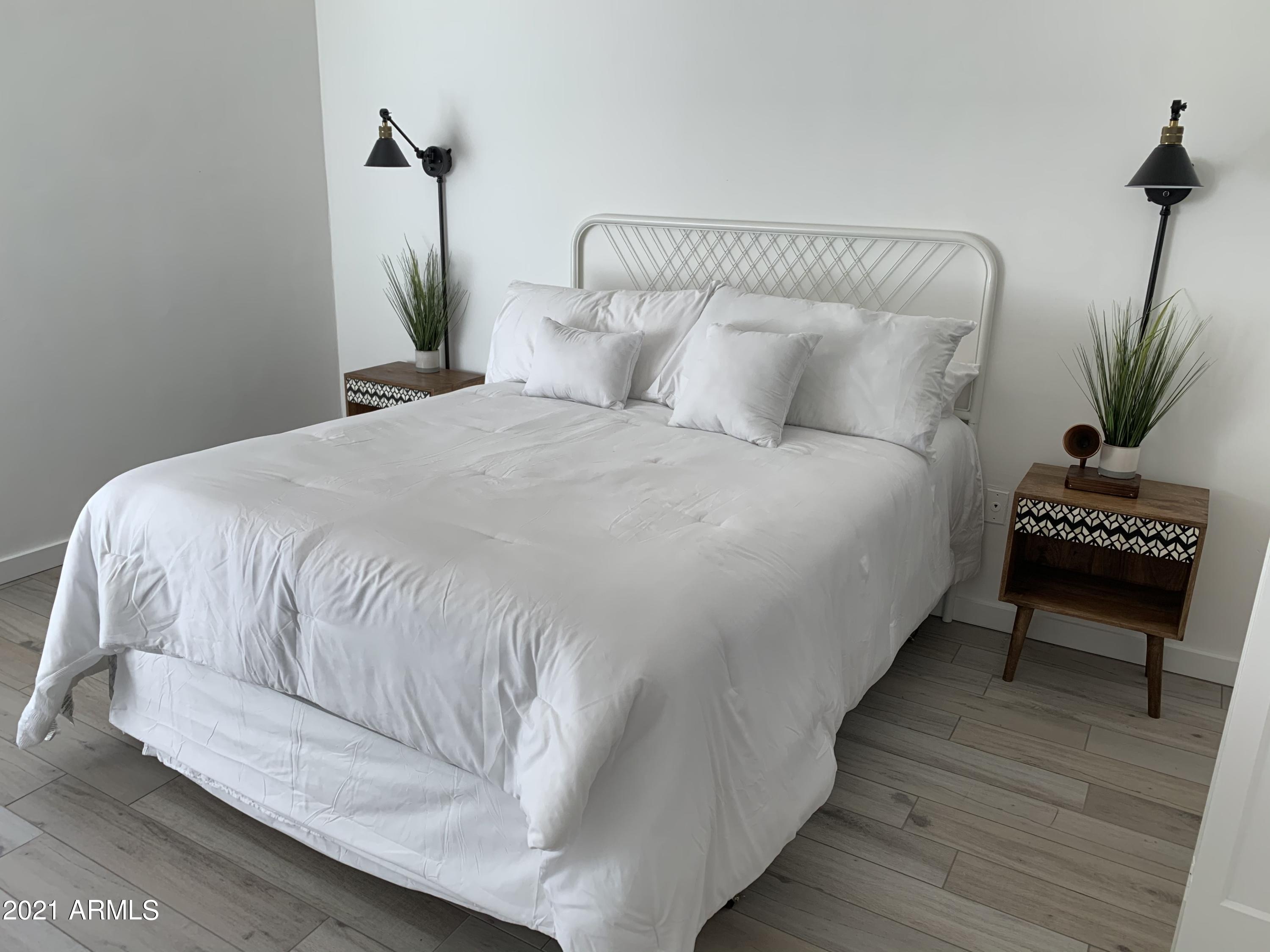 3416 North 44th Street, Unit 34 Phoenix, AZ 85018 - Photo 11 of 41 a bedroom with a bed and a potted plant on table