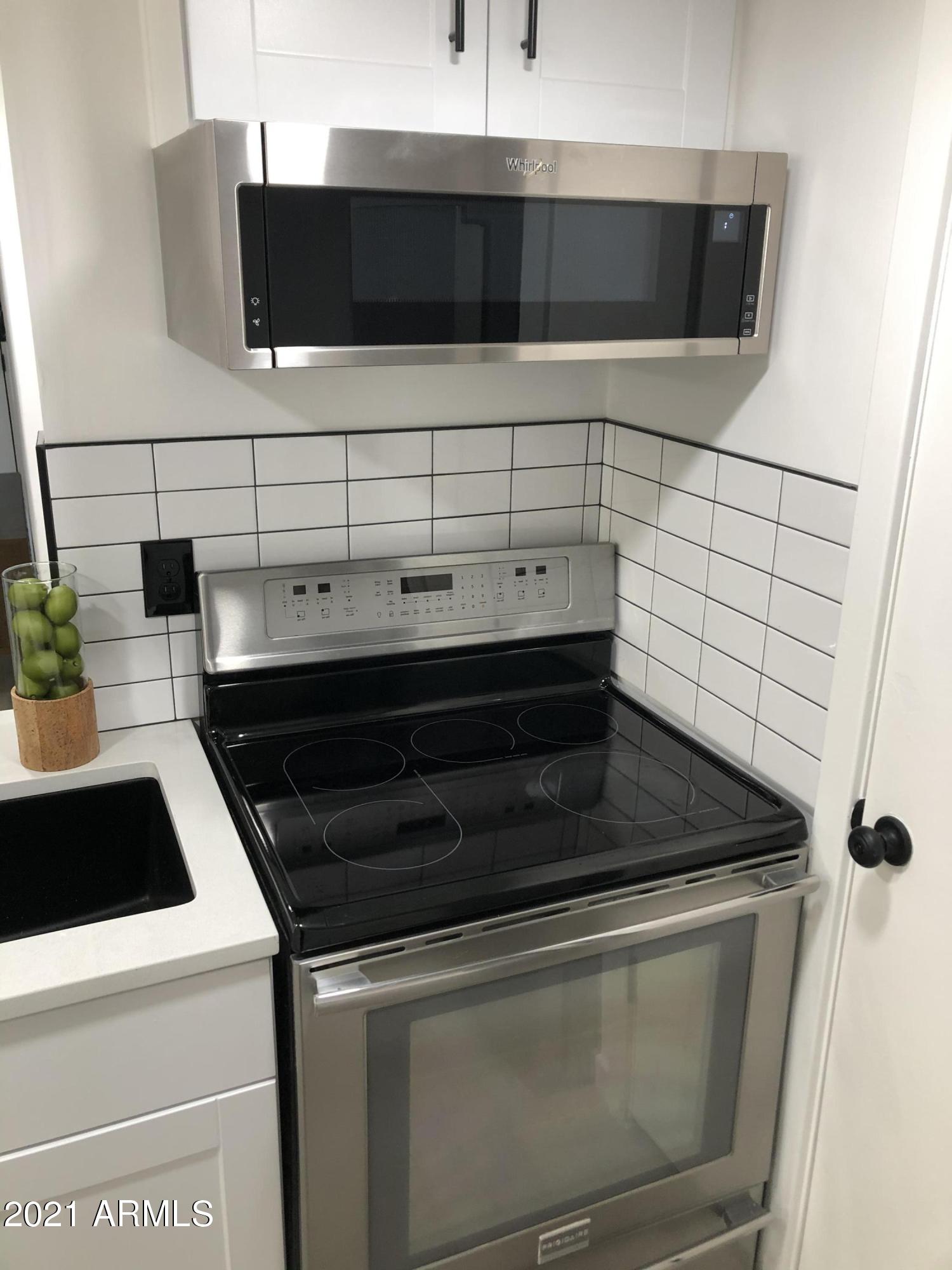 3416 North 44th Street, Unit 34 Phoenix, AZ 85018 - Photo 15 of 41 a bathroom with a sink and a microwave
