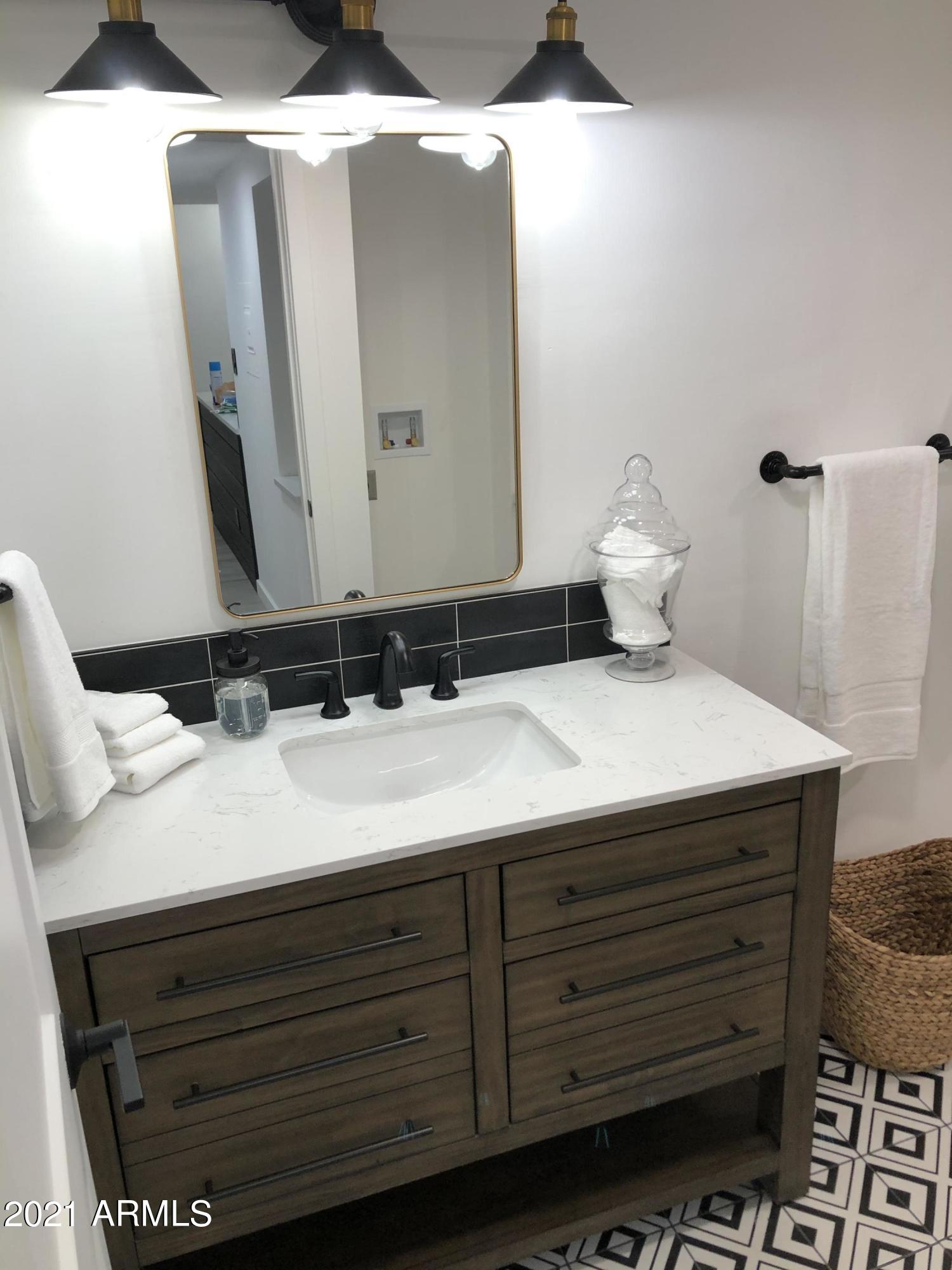3416 North 44th Street, Unit 34 Phoenix, AZ 85018 - Photo 17 of 41 a bathroom with a sink and a mirror