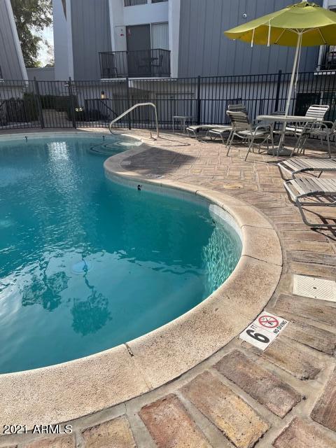 3416 North 44th Street, Unit 34 Phoenix, AZ 85018 - Photo 22 of 41 a view of a swimming pool with a patio