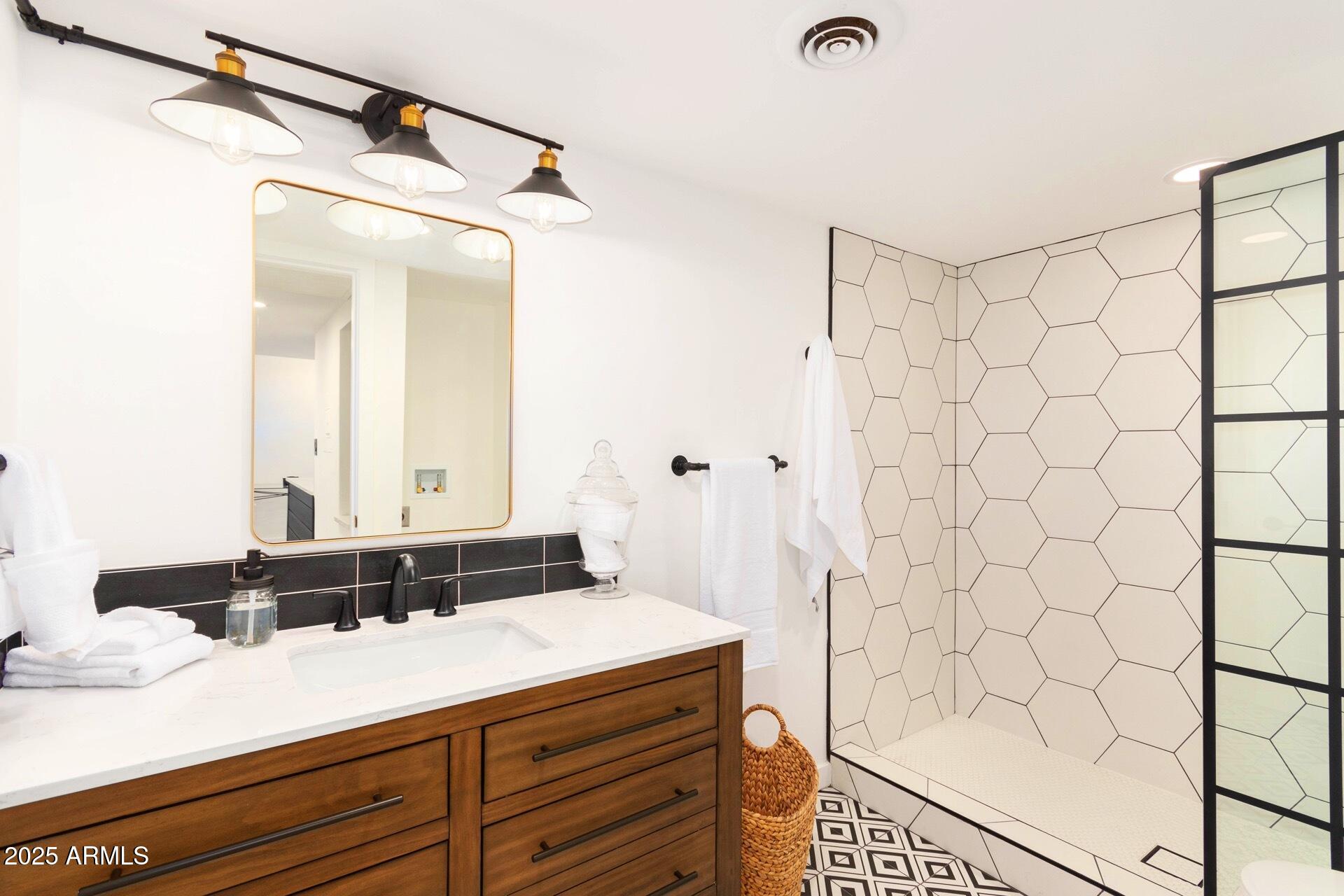 3416 North 44th Street, Unit 34 Phoenix, AZ 85018 - Photo 30 of 41 a bathroom with a granite countertop sink and a mirror