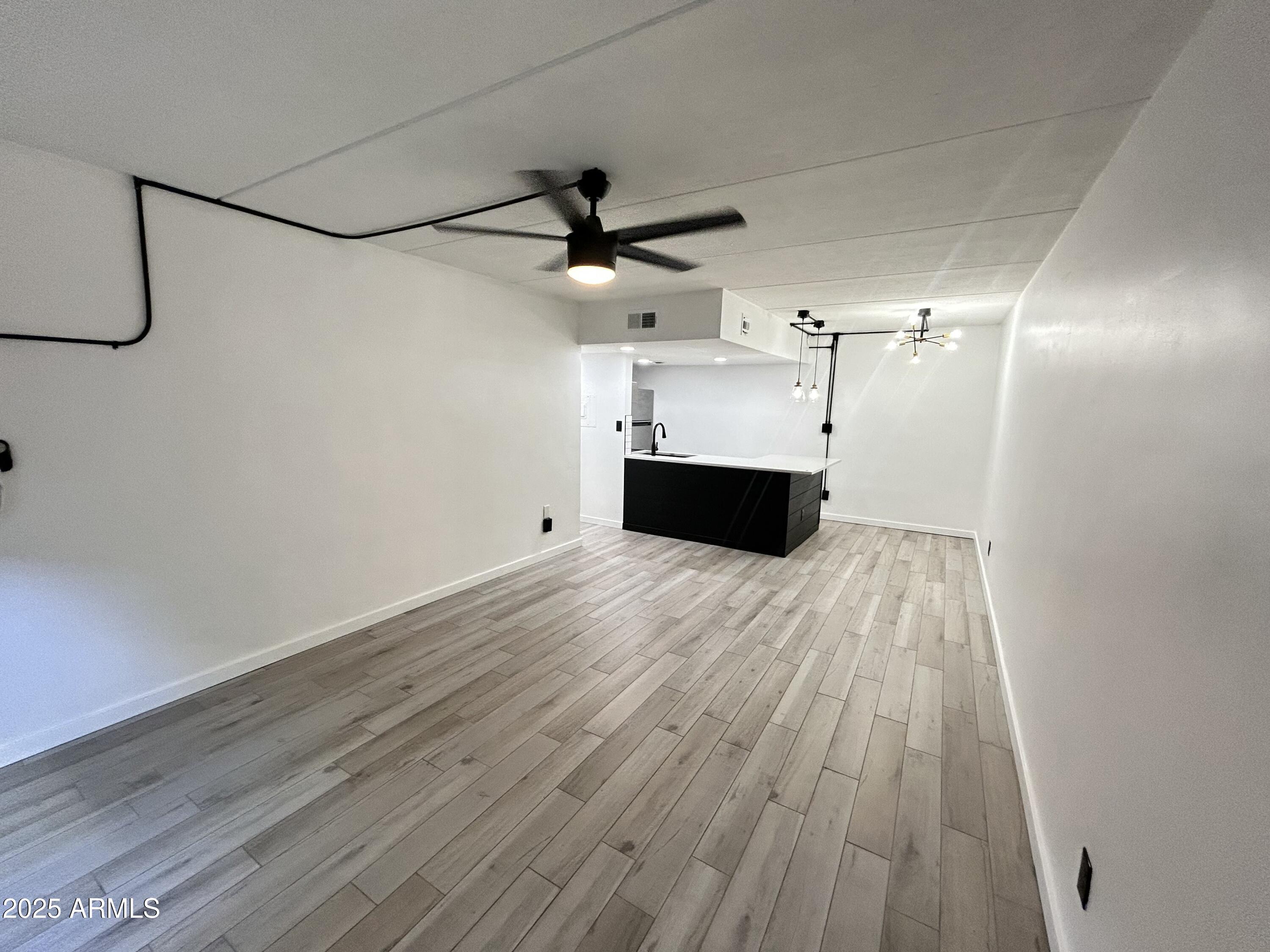 3416 North 44th Street, Unit 34 Phoenix, AZ 85018 - Photo 33 of 41 a view of empty room with wooden floor