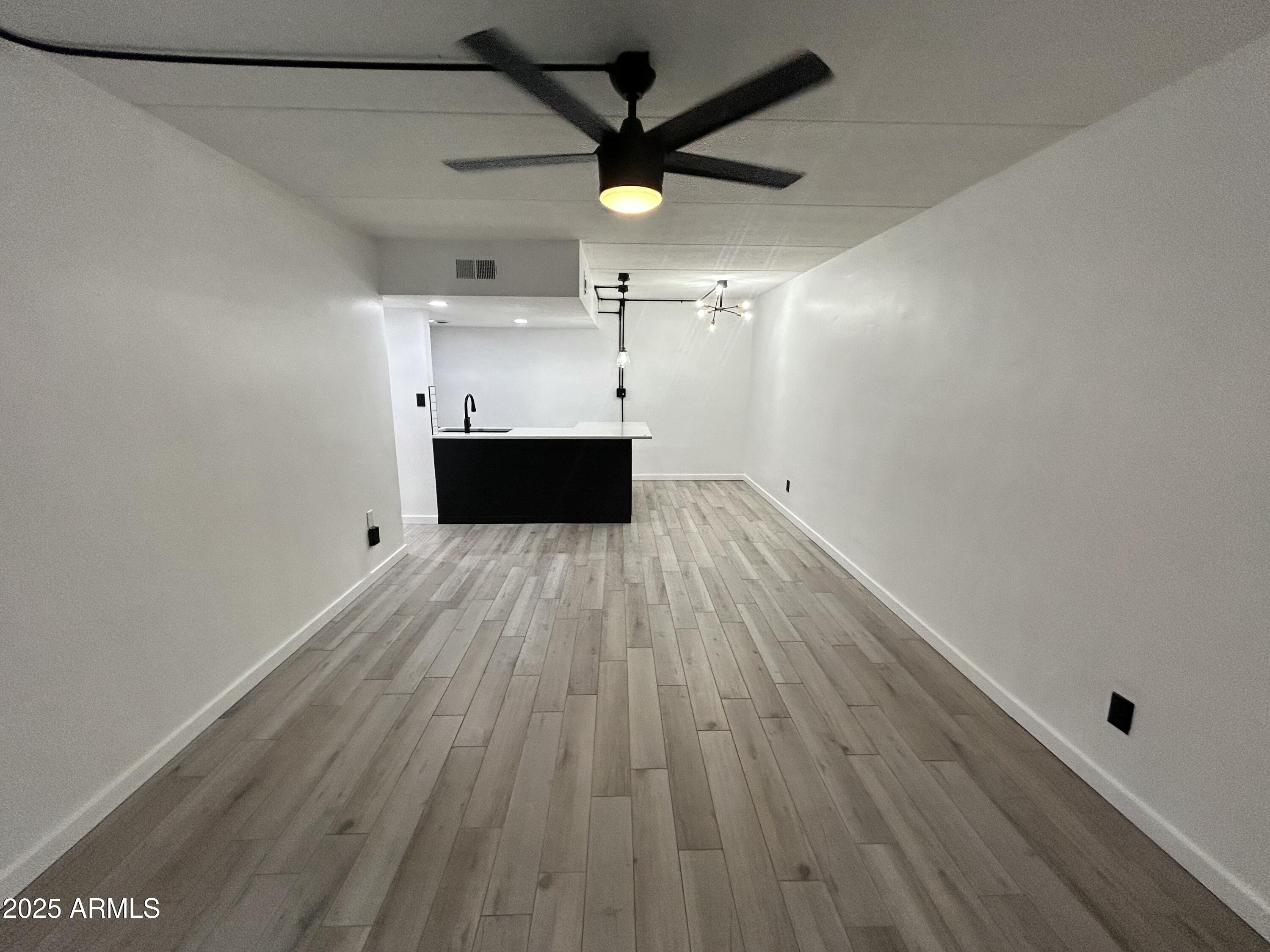 3416 North 44th Street, Unit 34 Phoenix, AZ 85018 - Photo 34 of 41 a view of a room with wooden floor