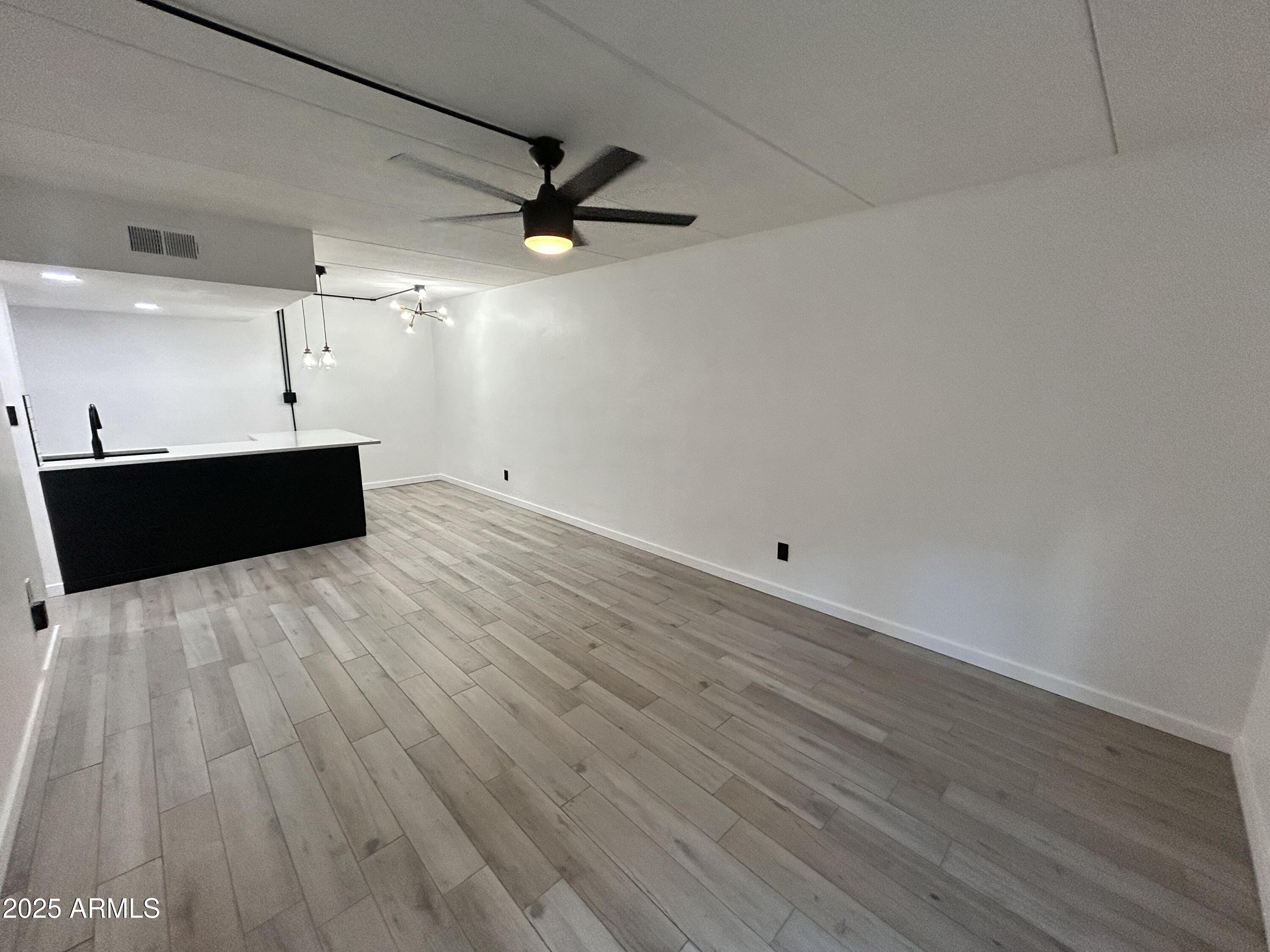 3416 North 44th Street, Unit 34 Phoenix, AZ 85018 - Photo 35 of 41 a living room with hard wood floors and a ceiling fan