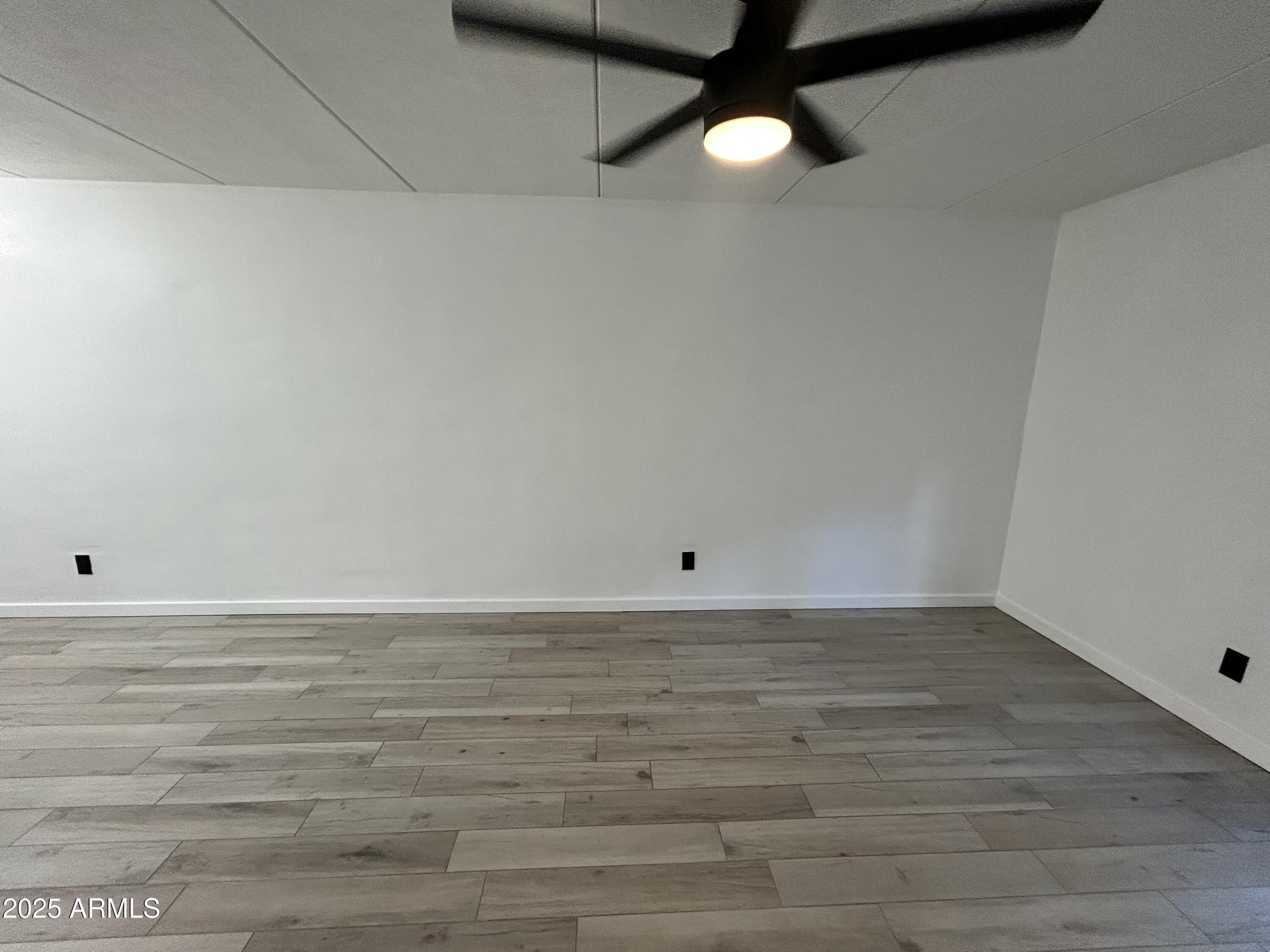 3416 North 44th Street, Unit 34 Phoenix, AZ 85018 - Photo 36 of 41 a view of a room with wooden floor and fan