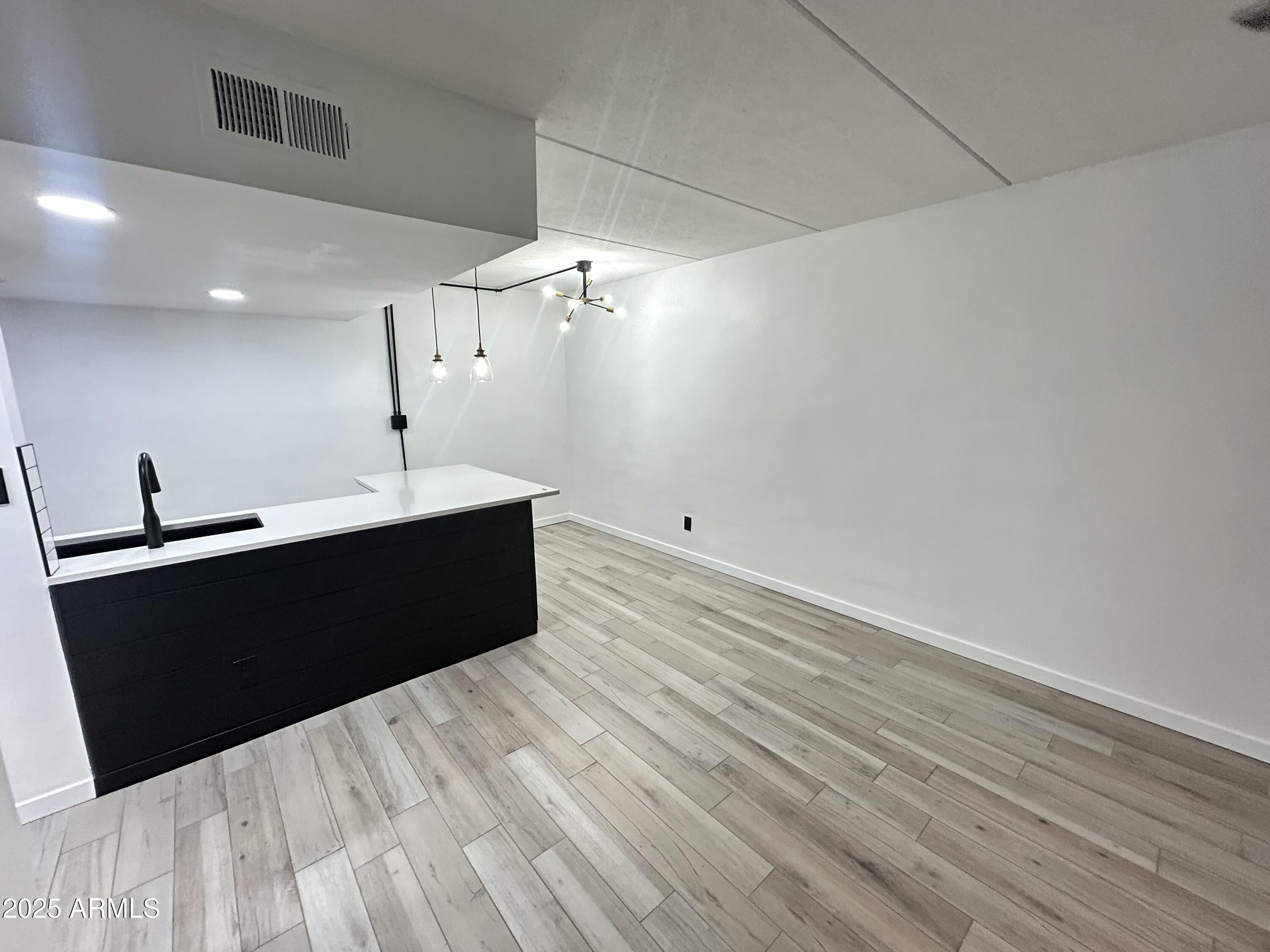 3416 North 44th Street, Unit 34 Phoenix, AZ 85018 - Photo 38 of 41 a living room with a black white checkered floor with a sink and dishwasher