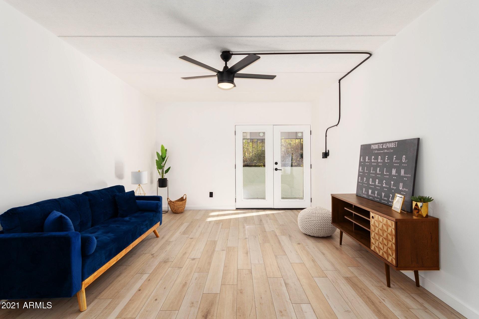 3416 North 44th Street, Unit 34 Phoenix, AZ 85018 - Photo 7 of 41 a living room with furniture and a rug