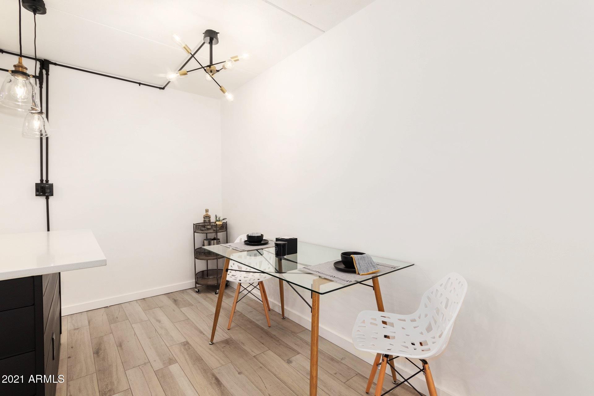 3416 North 44th Street, Unit 34 Phoenix, AZ 85018 - Photo 8 of 41 a workspace with furniture and wooden floor