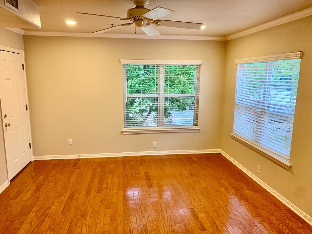 3009 Speedway, Unit 4 Austin, TX 78705 - Photo 12 of 16 a view of an empty room with a window and wooden floor