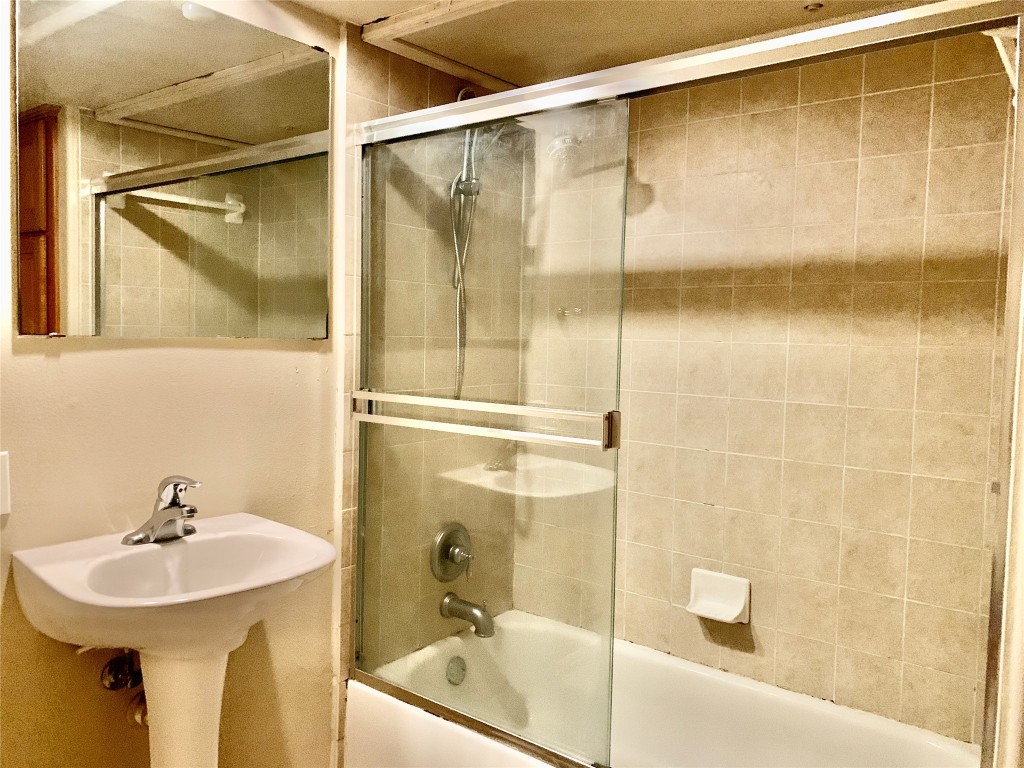 3009 Speedway, Unit 4 Austin, TX 78705 - Photo 9 of 16 a bathroom with a sink and mirror with bathtub