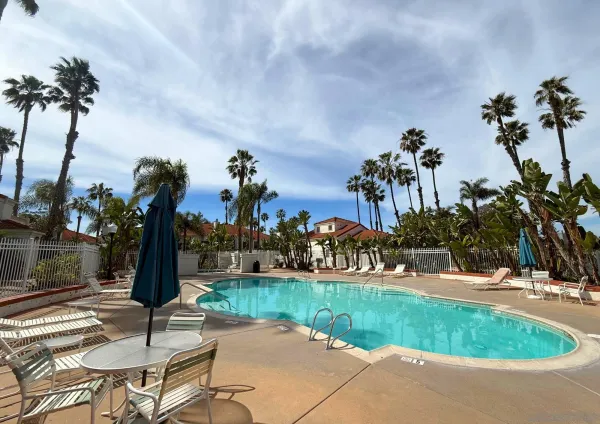 a swimming pool with outdoor seating and garden