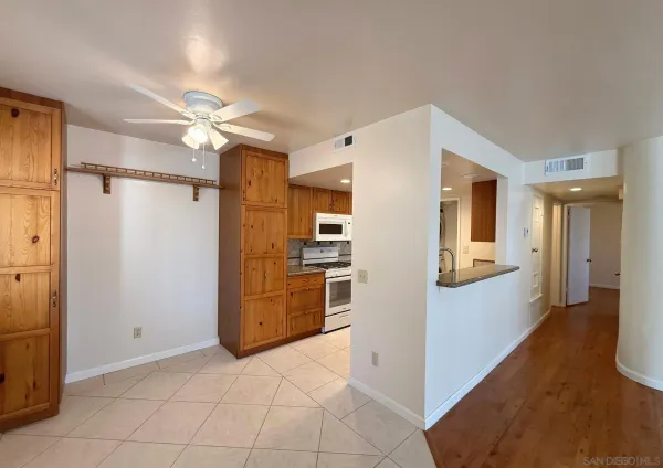 a view of a refrigerator in kitchen and a sink