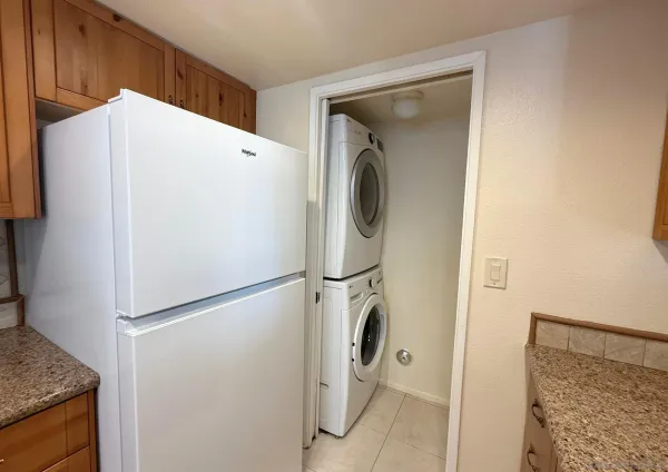 a white refrigerator freezer and a stove sitting inside of a kitchen