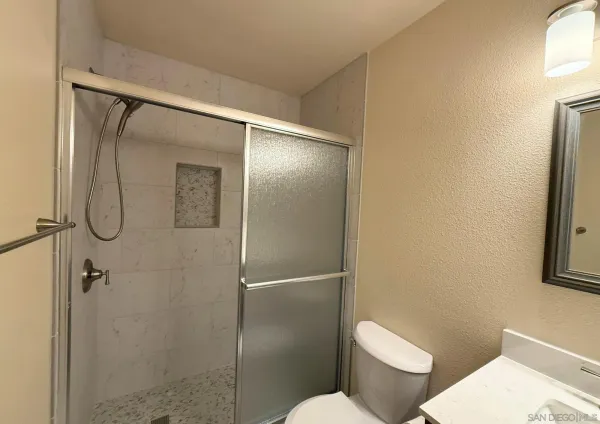 a bathroom with a toilet and a shower