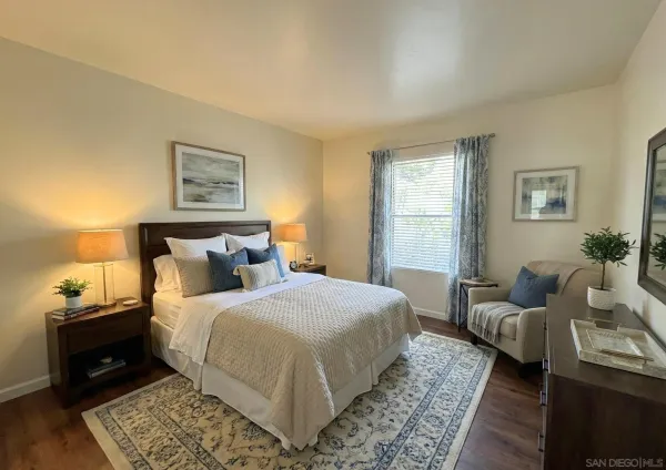 a bedroom with bed and wooden floor