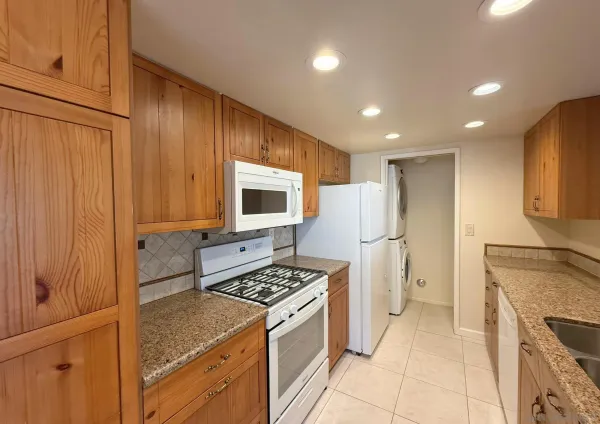 a kitchen with a stove and a refrigerator