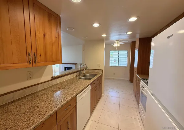 a large kitchen with kitchen island granite countertop a sink window and stainless steel appliances