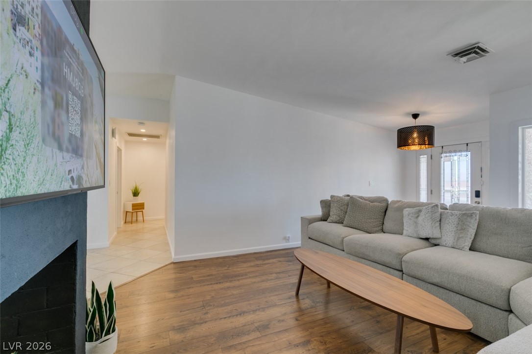 892 North Hollywood Boulevard Las Vegas, NV 89110 - Photo 19 of 81 This bright living space features wood flooring, an elegant fireplace, and a stylish entryway.